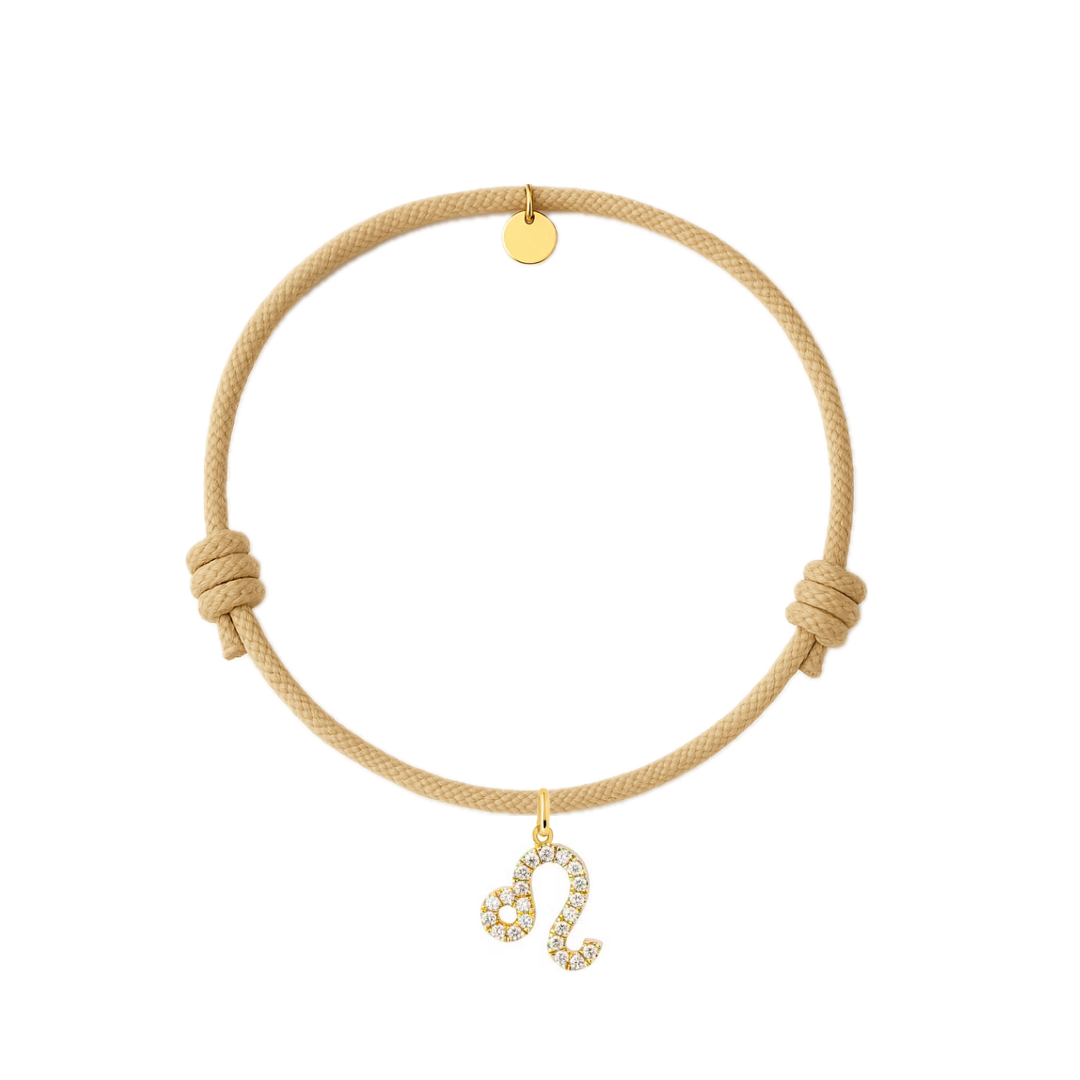 bracciale con cordino beige e ciondolo dorato e zirconi.