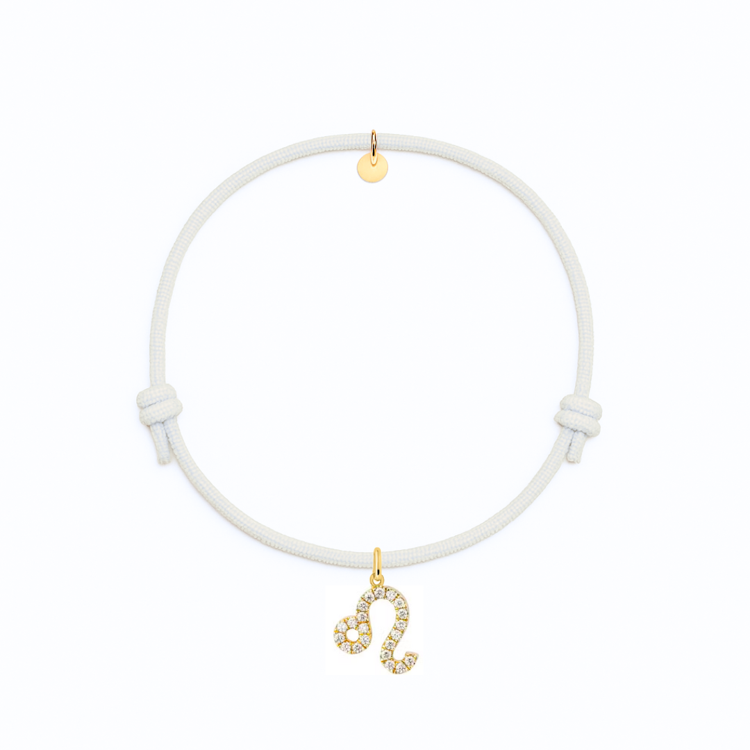bracciale con cordino bianco e ciondolo dorato con zirconi