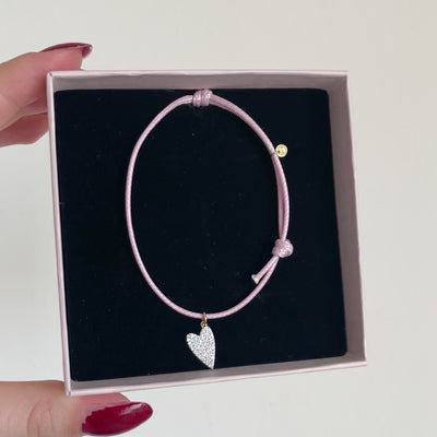 bracciale in cordino rosa con ciondolo cuore realizzato in pavé di zirconi 
